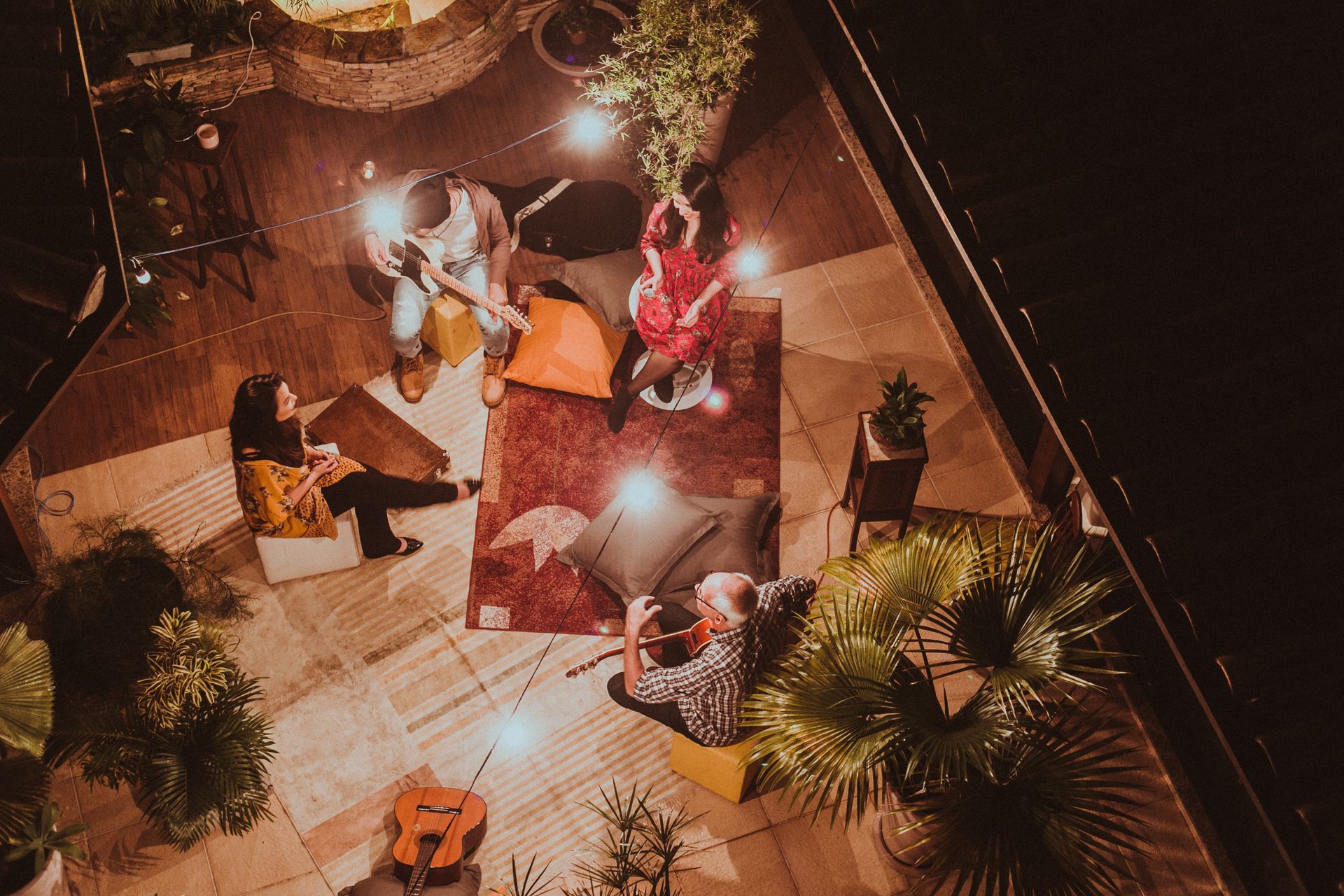 Overhead view of musicians gathered in a circle with instruments
